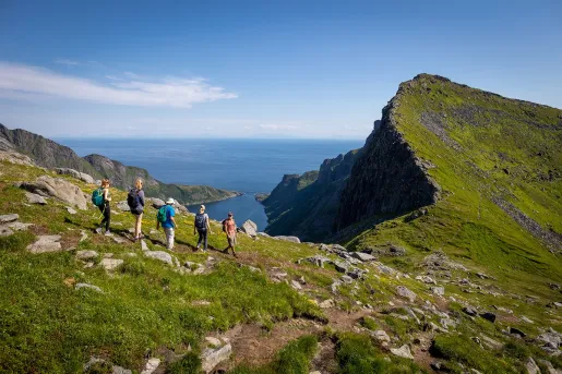 A family hiking near a cliff in Norway's Lofoten Islands.