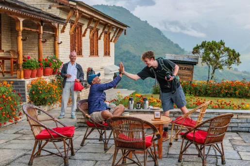 Two men high-fiving with a large forest in the distance
