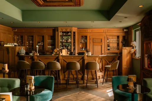 Bar and lounge with wooden walls and brown bar stools
