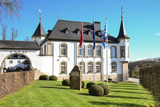 Exterior view of castle-like building with a trimmed lawn in front