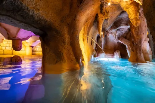 Underground cavern poo with blue and orange, illuminated lights