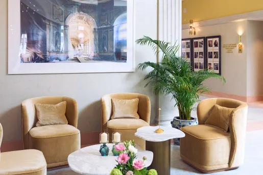 Lounge and seating area with four, beige chairs and a circular coffee table