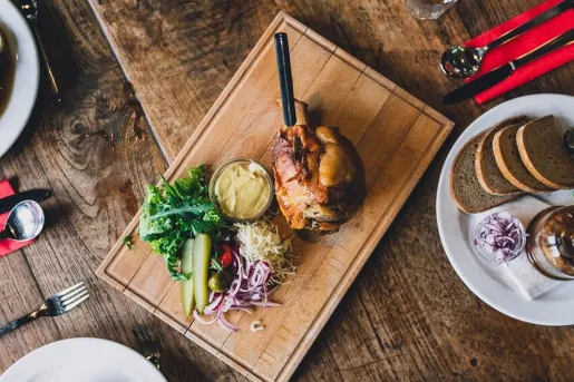 Slow-roasted pork with sides of pickles, mustard and sauerkraut at Boutique Hotel Latrán in the Czech Republic.