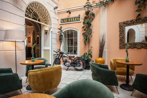 Outdoor patio with cushioned chairs and circular tables