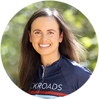 Woman smiling while wearing a Backroads bike jersey