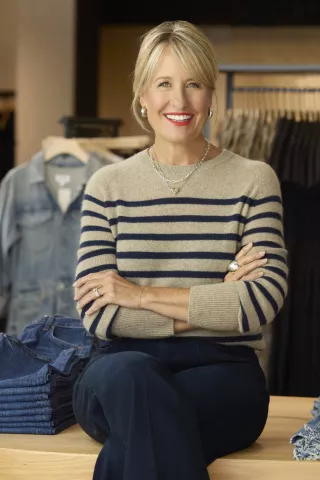 Woman in a striped sweater, smiling with her arms crossed