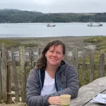 Woman smiling with a valley in the background