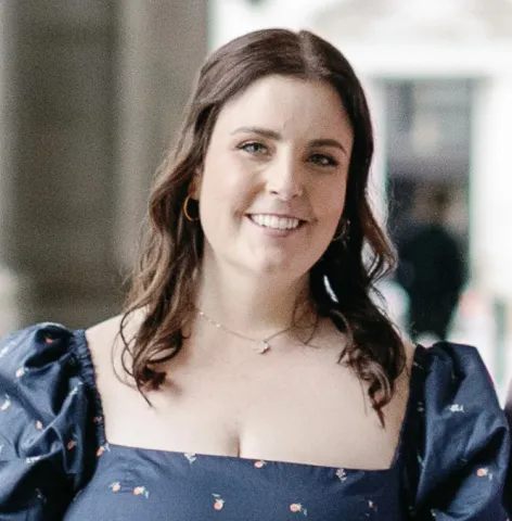 Woman wearing a blue dress, smiling