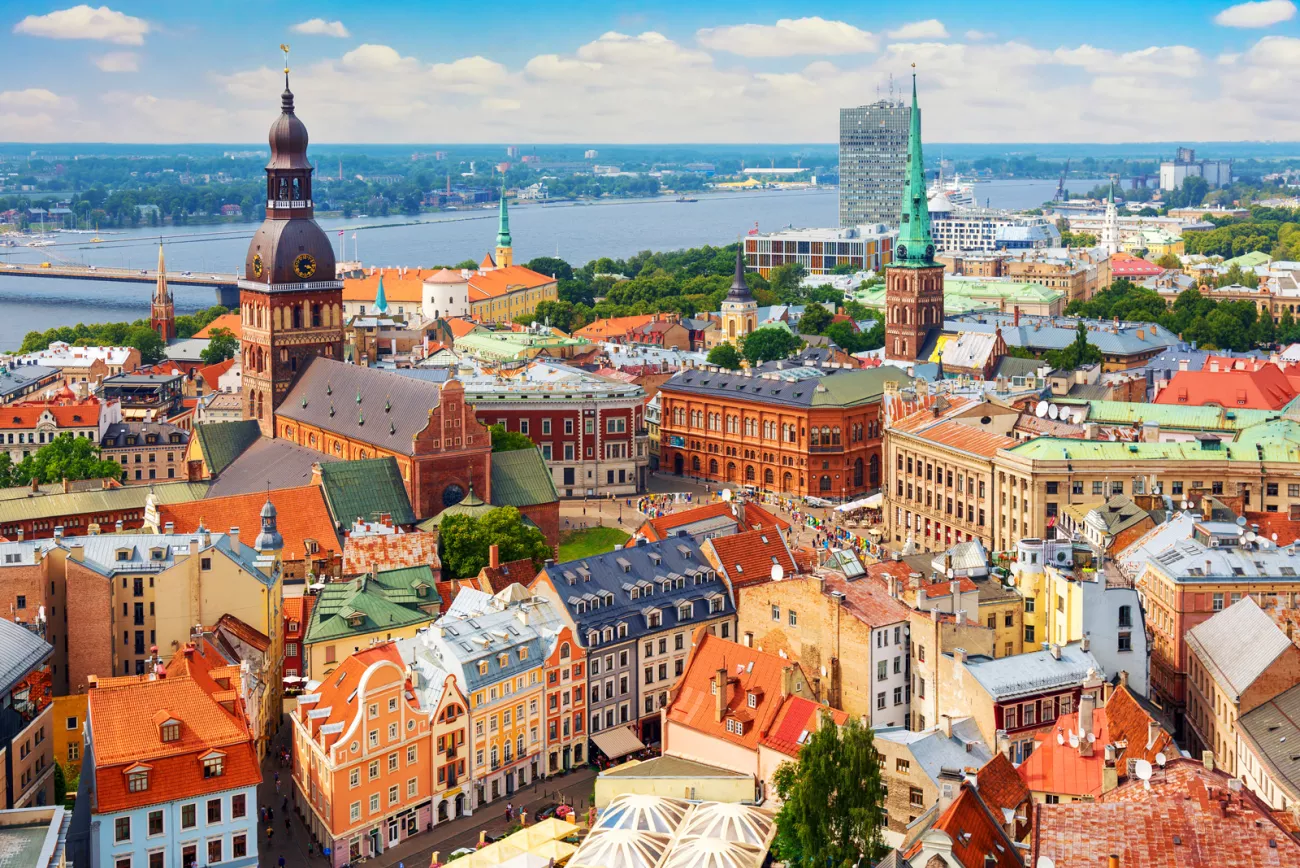 Sky view of a European town with orange apartment building and a large river in the background