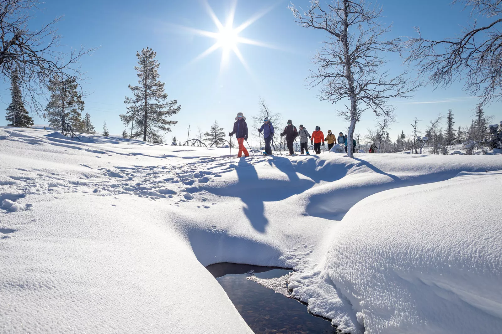 Group of people walking in a valley of snow