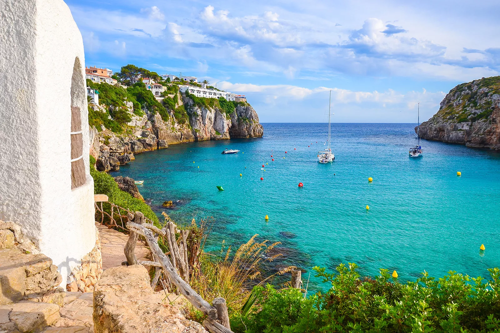 Coastside cliff with boats floating in the ocean