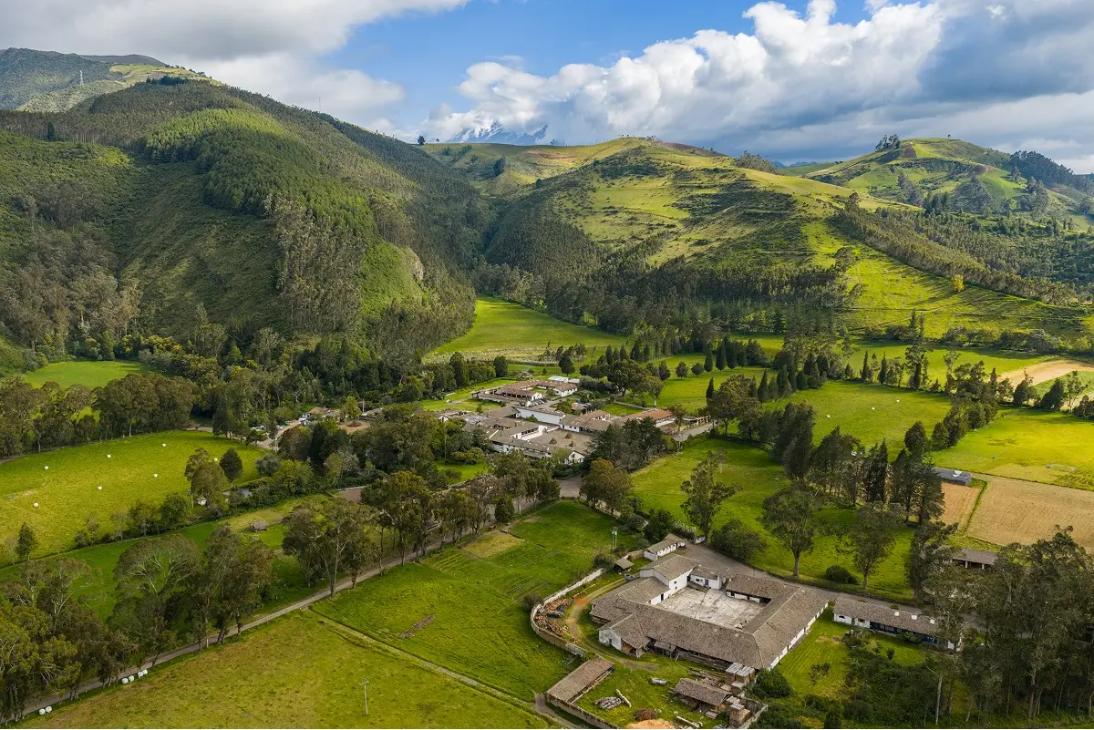 Sky view of a large valley with trees and small houses