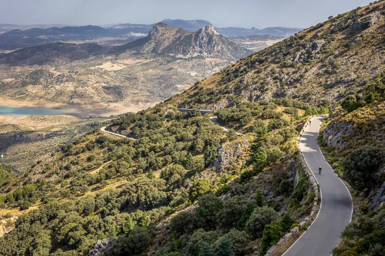 Two Backroads' guests biking on road in mountains, Spain.