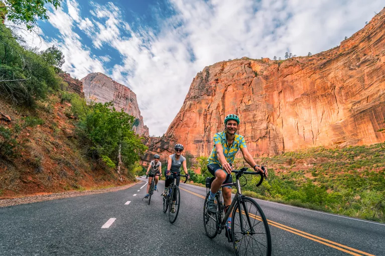 Below eye-level shot of three bikers in canyon