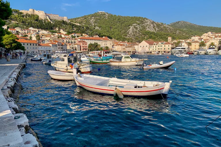 Coastal town and houses, boats scattered about.