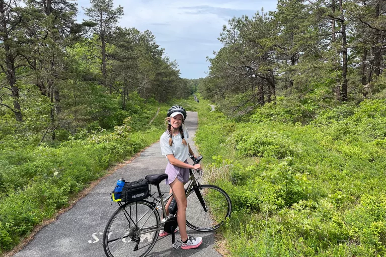 Young guest on small backroad with bike.