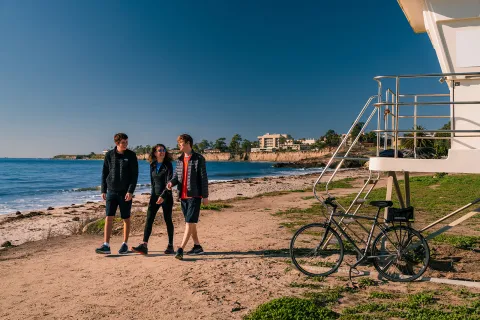 People walking along California beach.