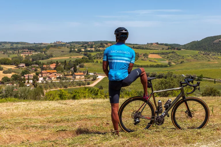 Rear shot of guest with bike, looking towards vineyard town.