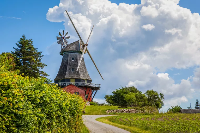 Windmill with dramatic clouds hovering over