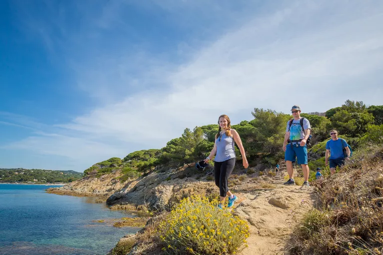 Group of three Backroads guests hiking beside the sea in France