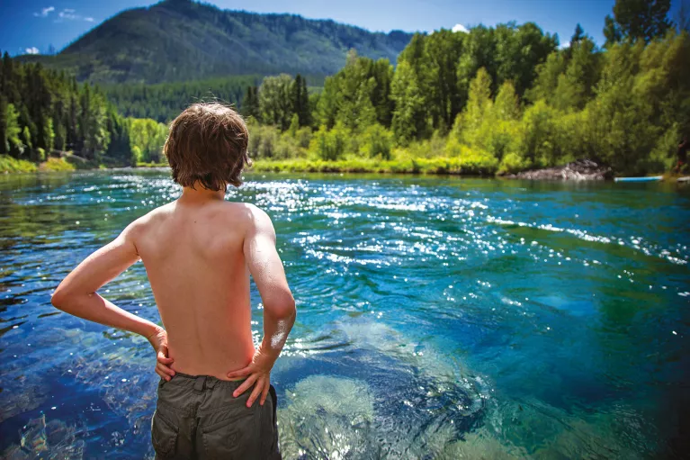 Backroads guest looking out at blue water and mountains