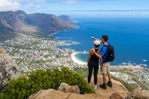 Couple standing on an overlook above a coastal town