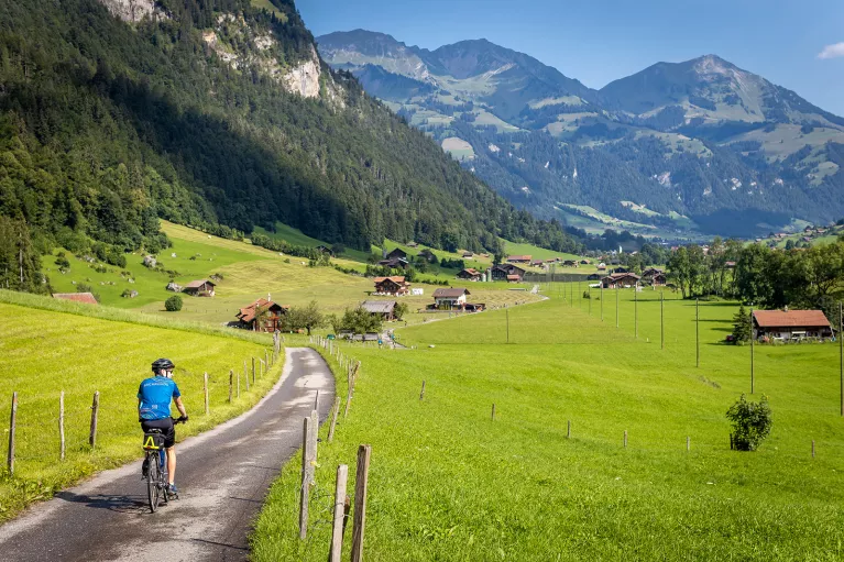 Guest cycling towards mountain village.