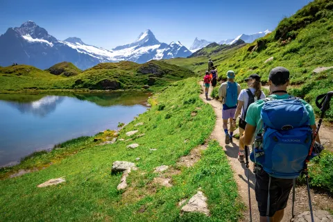 Group of guests walking past Bachalpsee Lake,