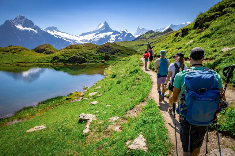 Group of guests walking past Bachalpsee Lake,
