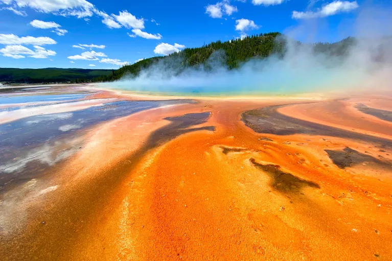 Orange sand leading up to smoking hot springs 