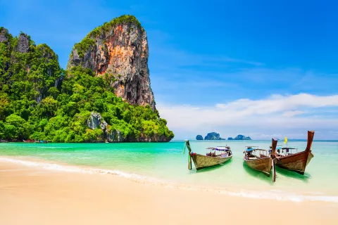 Boats resting on a sandy beach in Thailand