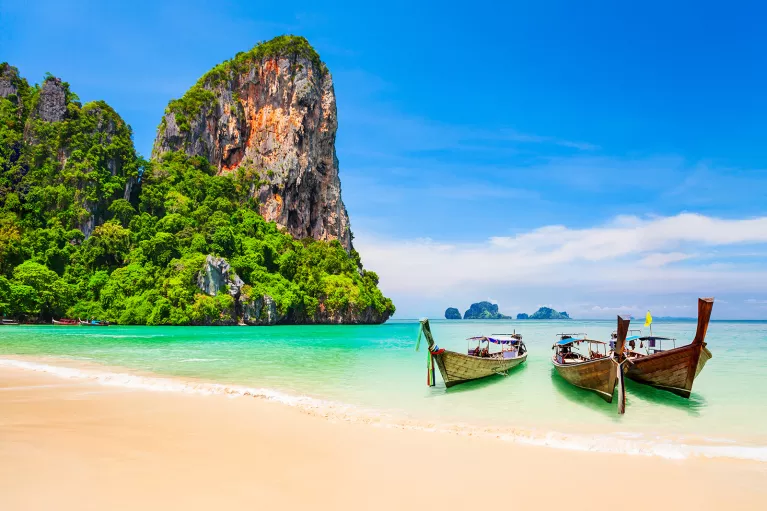 Boats resting on a sandy beach in Thailand