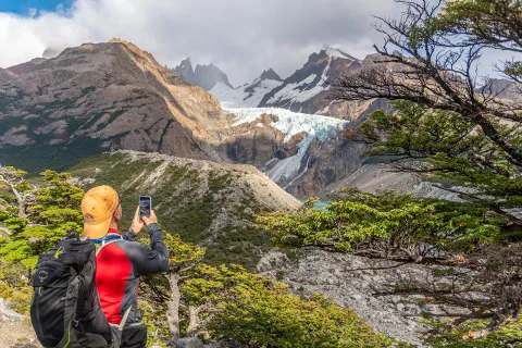 Guest taking photo of snowy mountain.