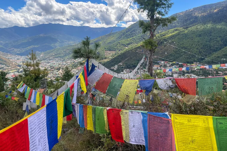 Brightly colored flags strung up above a valley in Bhutan