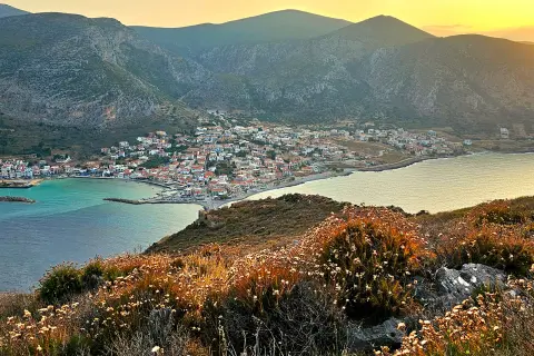 Wide shot of coastal Mediterranean town during sunset.