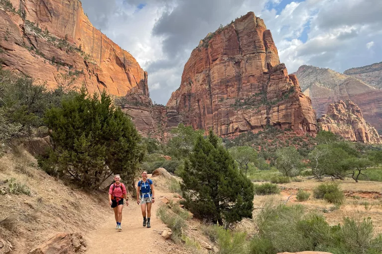Hikers walking on trail in canyon