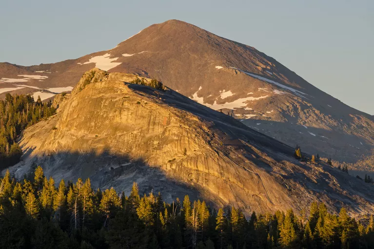 Wide shot of semi-snowy mountain.