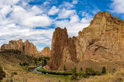 Large, jagged mountains and cliffs in a large gravel valley