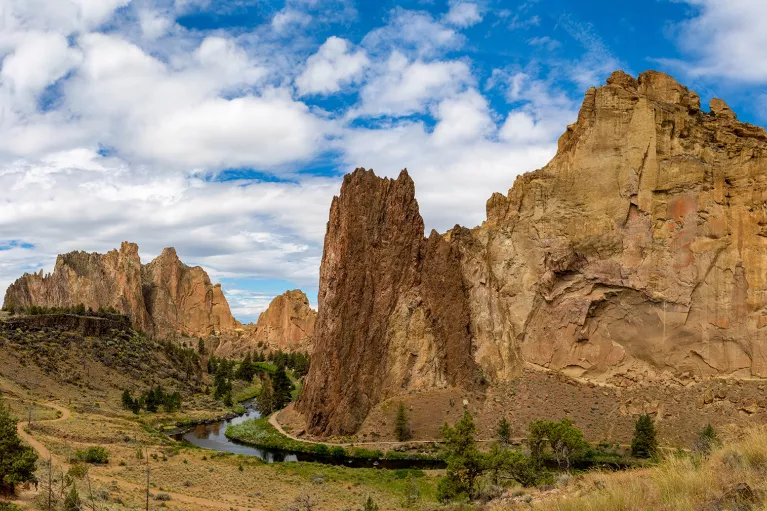 Large, jagged mountains and cliffs in a large gravel valley