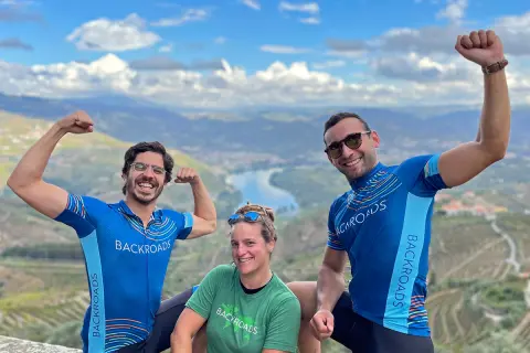 Two men and one woman flexing their muscles