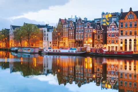 Houses lit up along a canal