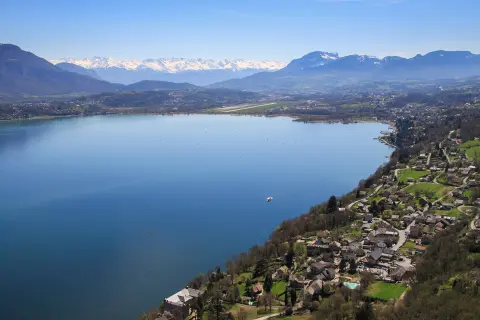 A large lake surrounded by houses and mountains