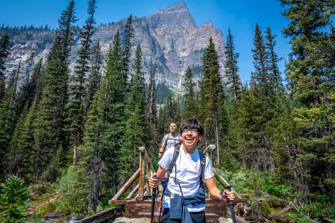 Backroads guest hiking across a bridge