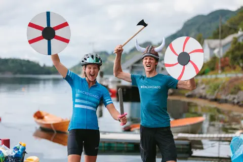 Man and women with plush Viking helmets and weapons
