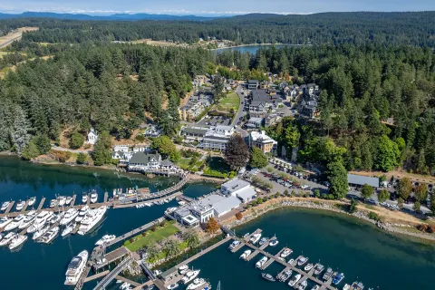 Sky view of a property complex with boats along a port 