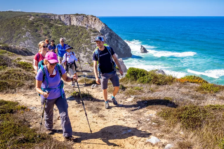 Hikers walking up a shoreline trail