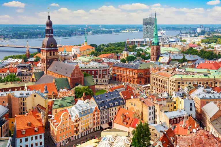 Sky view of a European town with orange apartment building and a large river in the background