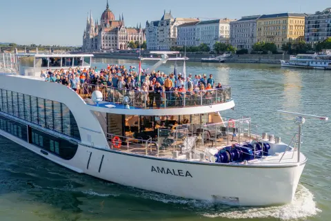Giant boat with a large group of people on top, smiling