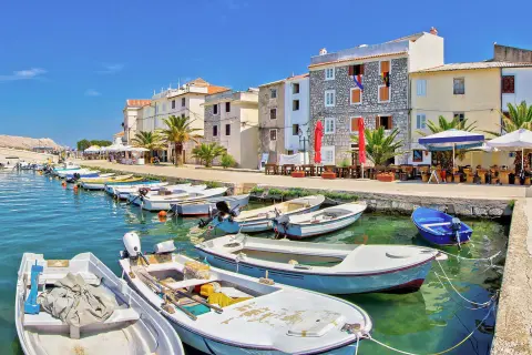 Boats docked by a row of houses