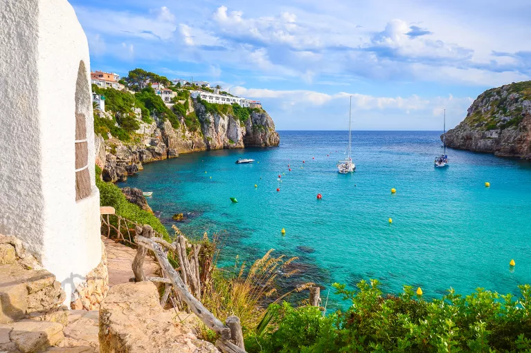 Coastside cliff with boats floating in the ocean